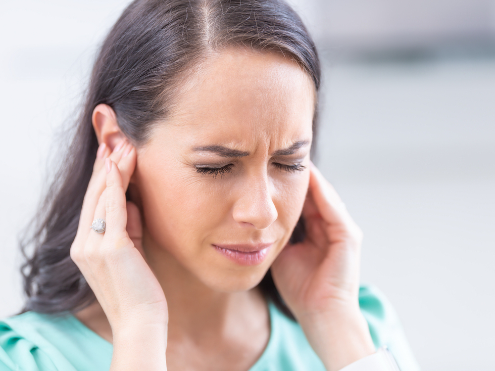 Doctor of Audiology evaluating a patient for tinnitus and ringing in the ears at Advanced Hearing Technology in Naples, FL
